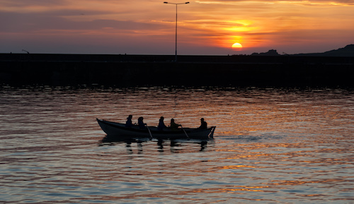 Rowing boat in sunset